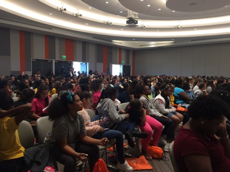 Girls listening to speakers at the conference.