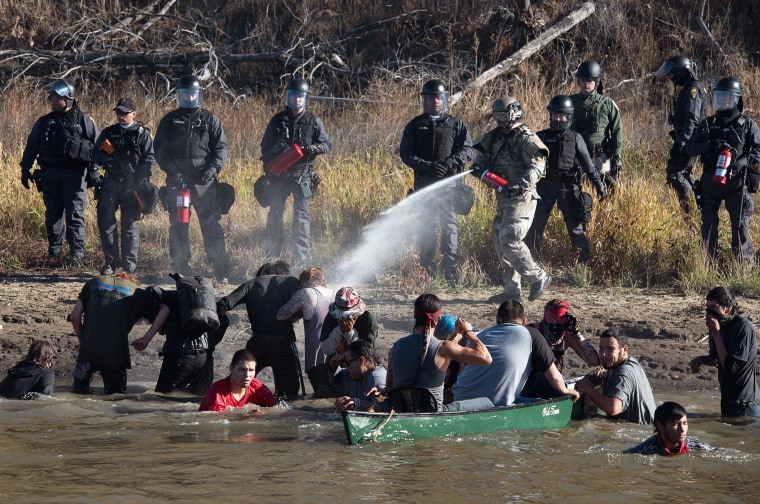 Image: Police use pepper spray against protesters trying to cross a stream near an oil pipeline construction site near Standing Rock Indian Reservation, north of Cannon Ball