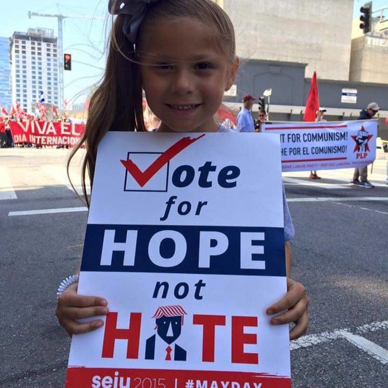 7-year-old Rosita Escobedo holds an anti-Donald Trump protest sign to combat bullying.