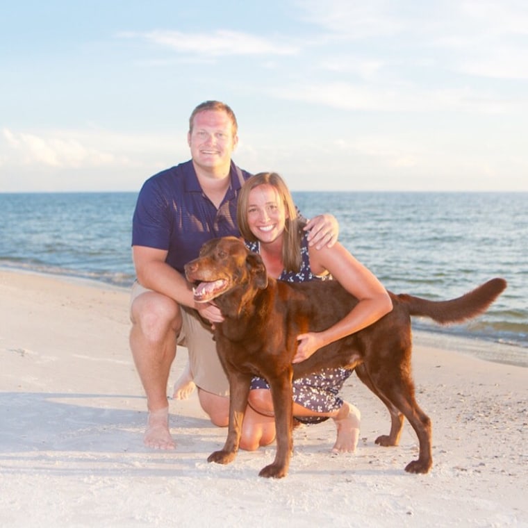 Jennifer Dew with her husband, Ryan and one of their "fur children," their dog.