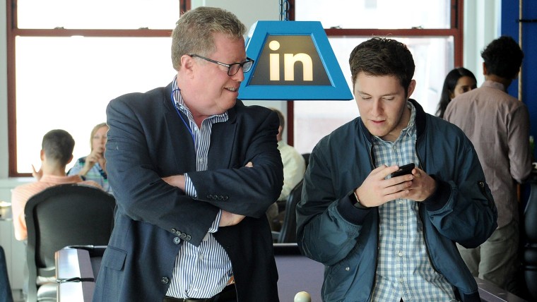 LinkedIn employee giving his dad a technology tutorial on Take Your Parents To Work Day.