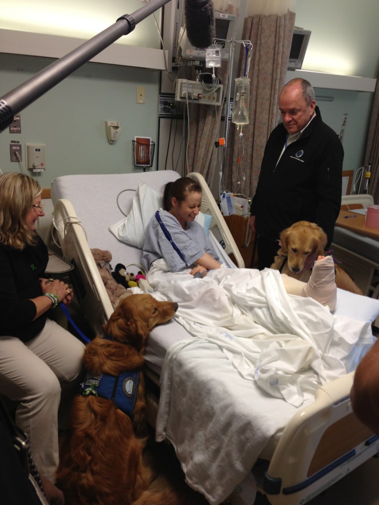 Lee Ann Yanni gets a visit in the hospital from comfort dogs after Boston Marathon bombings.