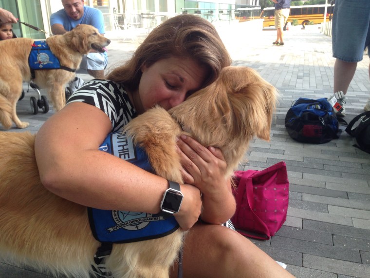 Ruthie gets a hug from a grieving person after the Orlando nightclub shooting.