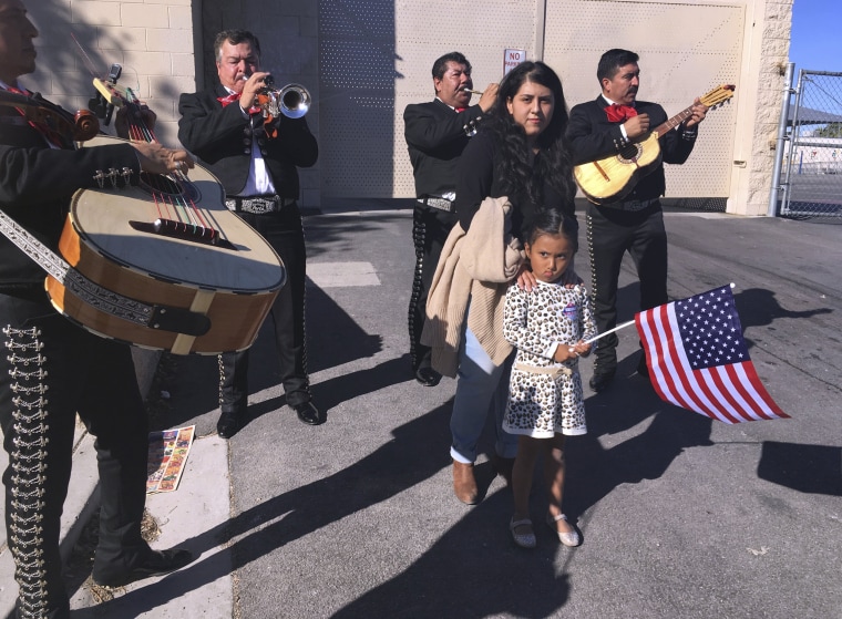 Image: A voter gets serenaded by a mariachi group