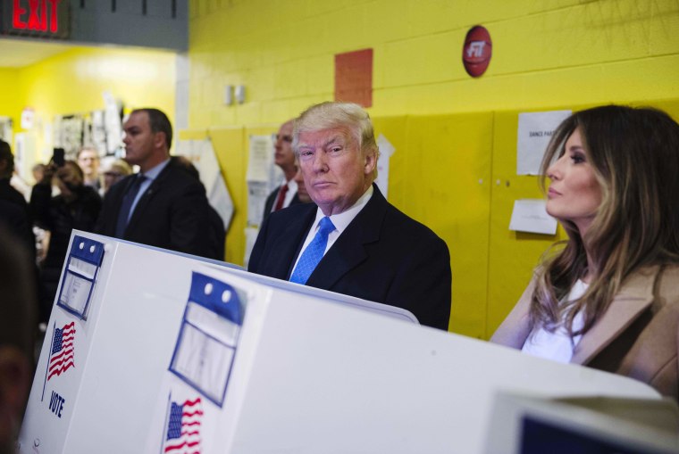 Image: Trump fills out his ballot at a polling station