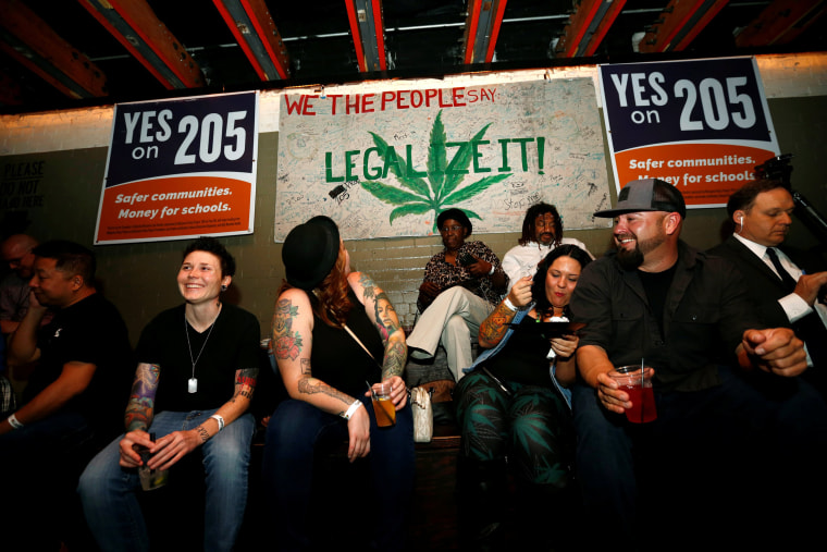 Image: People gather for an election watch party put on by supporters of a legal marijuana initiative in Phoenix, Arizona