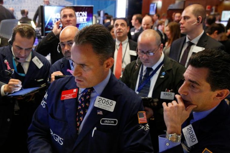 Traders work on the floor of the NYSE