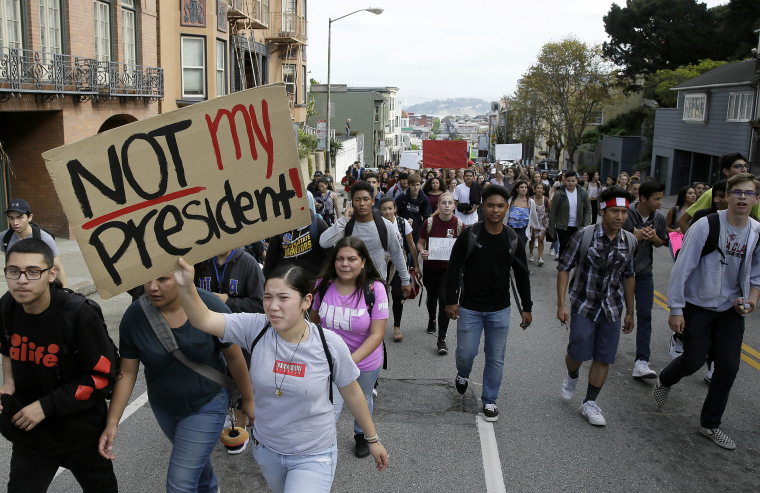 Image: High school students carry signs as they march in opposition of Donald Trump's presidential election victory in San Francisco