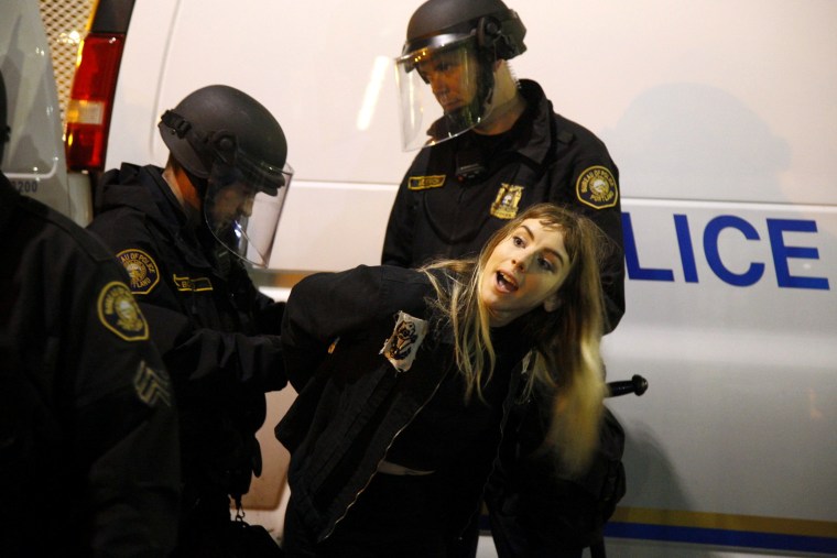 Image: Police detain a demonstrator during a protest in Portland, Oregon