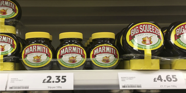 Image: Jars of Marmite are displayed for sale on a shelf at a Tesco supermarket near Manchester