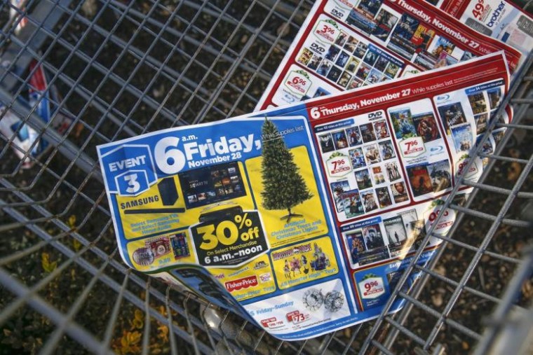 Black Friday advertisements are seen in the bottom of a shopping cart outside a shopping area in Westbury, New York