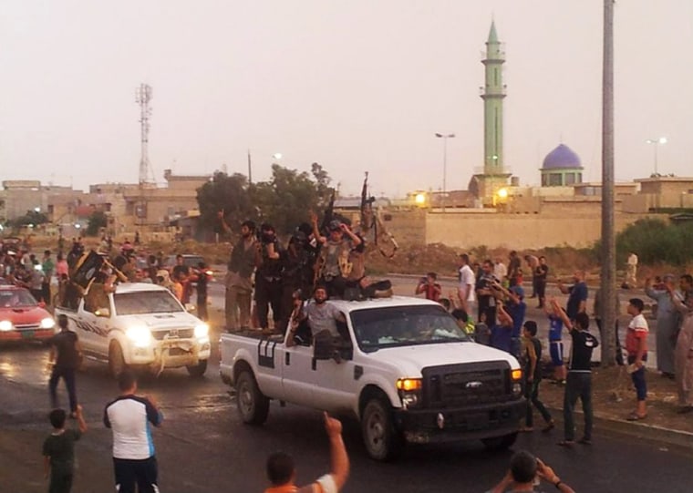 Image: ISIS fighters parade through Mosul, Iraq, on June 25