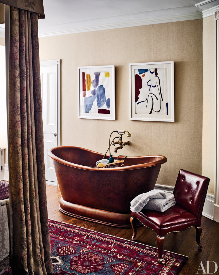A copper pedestal tub makes a style statement in the master bedroom.