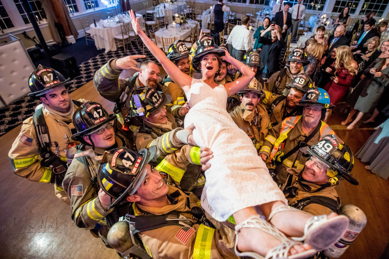 Firefighters hold up Allison Russoniello at her wedding. 