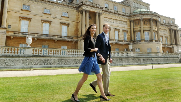 Britain's Prince William and Duchess of Cambridge walk outside Buckingham Palace