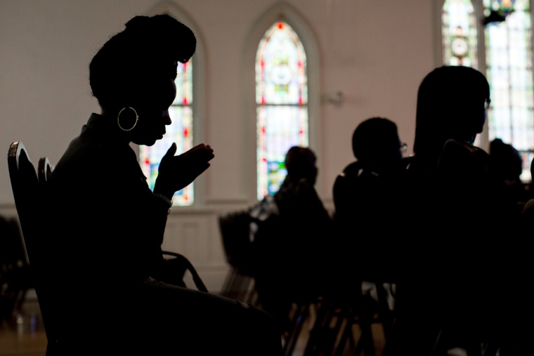 A woman prays during a church service at Pulse Church,