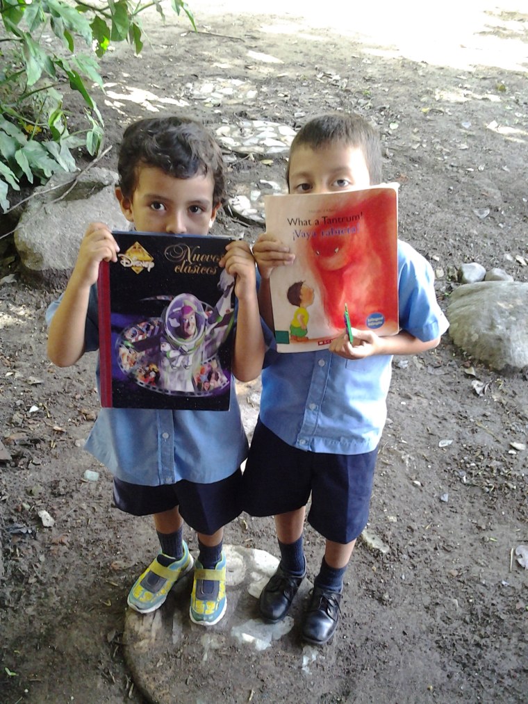 Students show their new books in San Jacinto, El Salvador. 