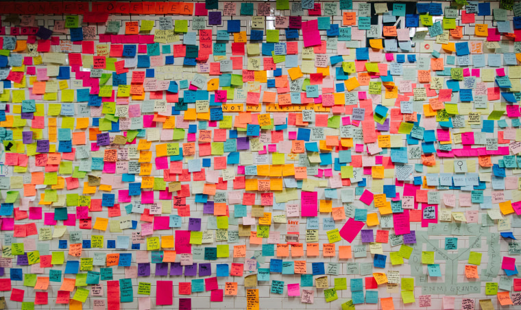 Image: A wall is covered with post-it notes as part of the art piece 'Subway Therapy' on the Union Square