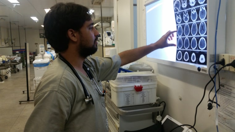 Dr. Mateus do Ros?rio evaluating a patient with neurological complications of Zika virus infection at Roberto Santos Hospital, Salvador-Brazil