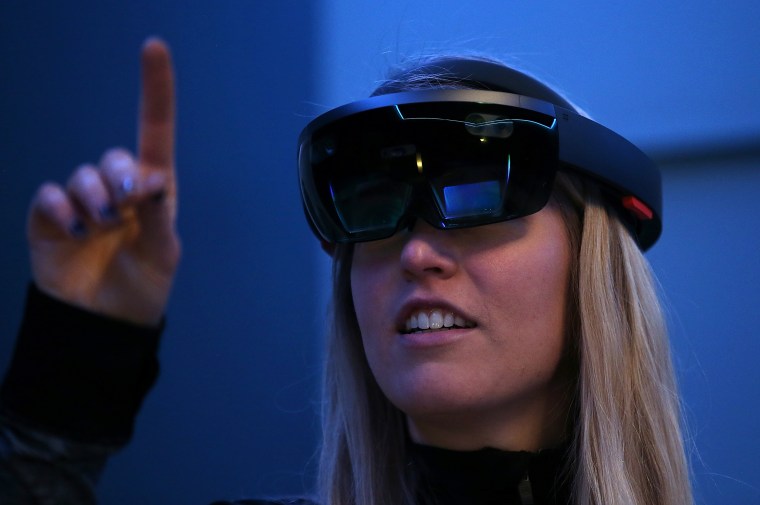 Image: A Microsoft employee demonstrates the Microsoft HoloLens augmented reality (AR) viewer