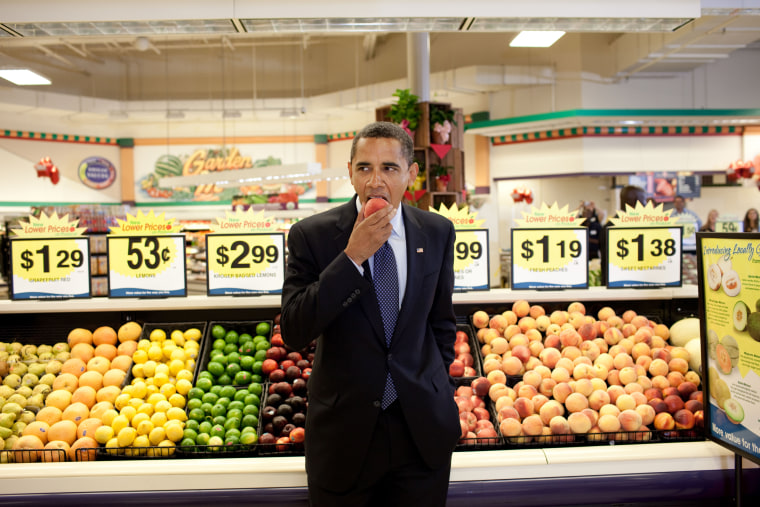 President Barack Obama eats a nectarine following a town hall meeting at Kroger's Supermarket in Bristol, Virginia. on July 29, 2009.
