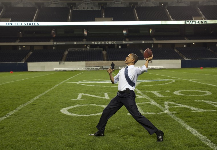 President Barack Obama throws a football on the field at Soldier Field following the NATO working dinner in Chicago, Illinois, May 20, 2012.