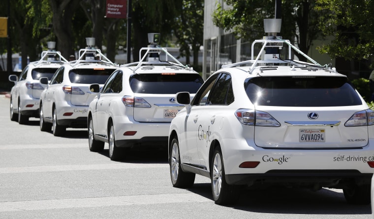 Image:  A row of Google self-driving cars are shown outside the Computer History Museum in Mountain View, Calif.