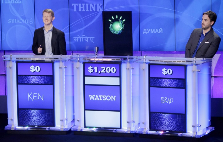 "Jeopardy!" champions Ken Jennings, left, and Brad Rutter, right, flank a prop representing Watson during a practice round of the "Jeopardy!" quiz show in Yorktown Heights, N.Y. on Jan. 13, 2011. (Photo by Seth Wenig/AP)