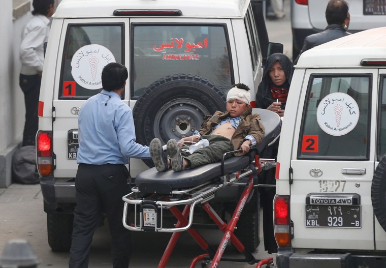 Image: An injured boy is transported to a hospital after a suicide attack in Kabul, Afghanistan