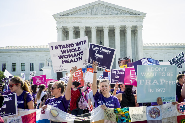 Image: Pro-choice and pro-life activists demonstrate on the steps of the  Supreme Court