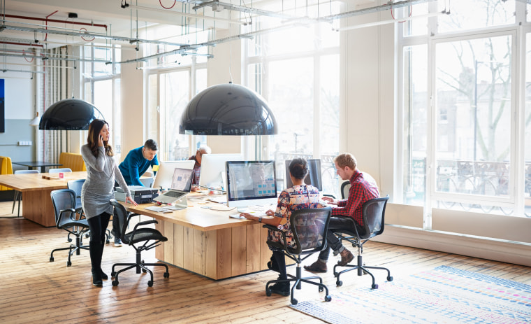 Co-workers working in start up office