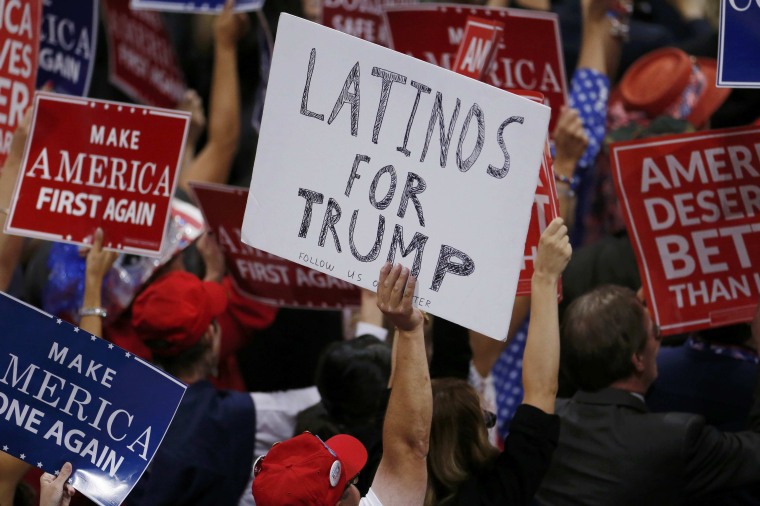 Image: A person holds a sign reading Latinos for Trump on the third day of the Republican National Convention in Cleveland, Ohio