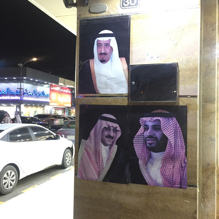 Image: Posters of Saudi Arabia's King Salman (top), Crown Prince Muhammad bin Nayef (bottom left) and Deputy Crown Prince Mohammad bin Salman