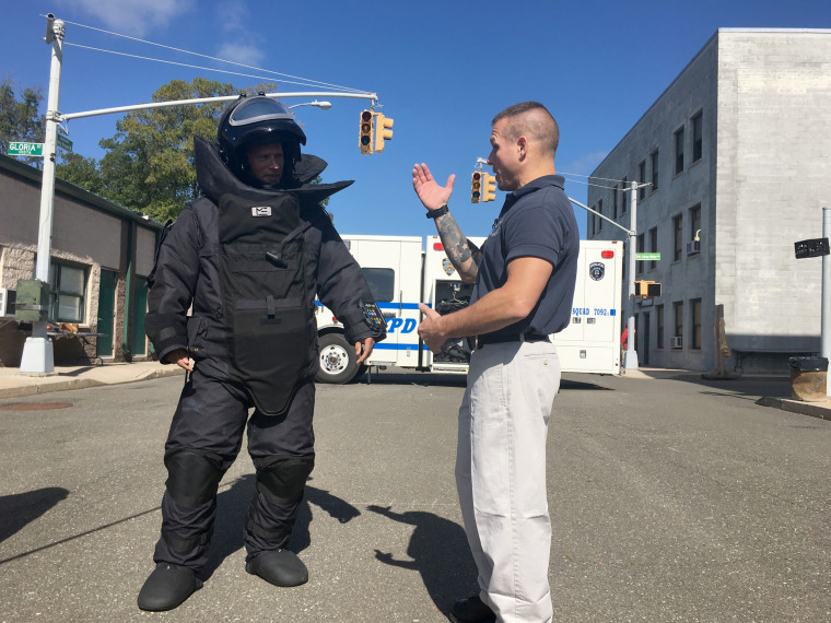 Lester Holt of NBC News (left, in bomb suit) with Det. Jason Hallik of the NYPD bomb squad.