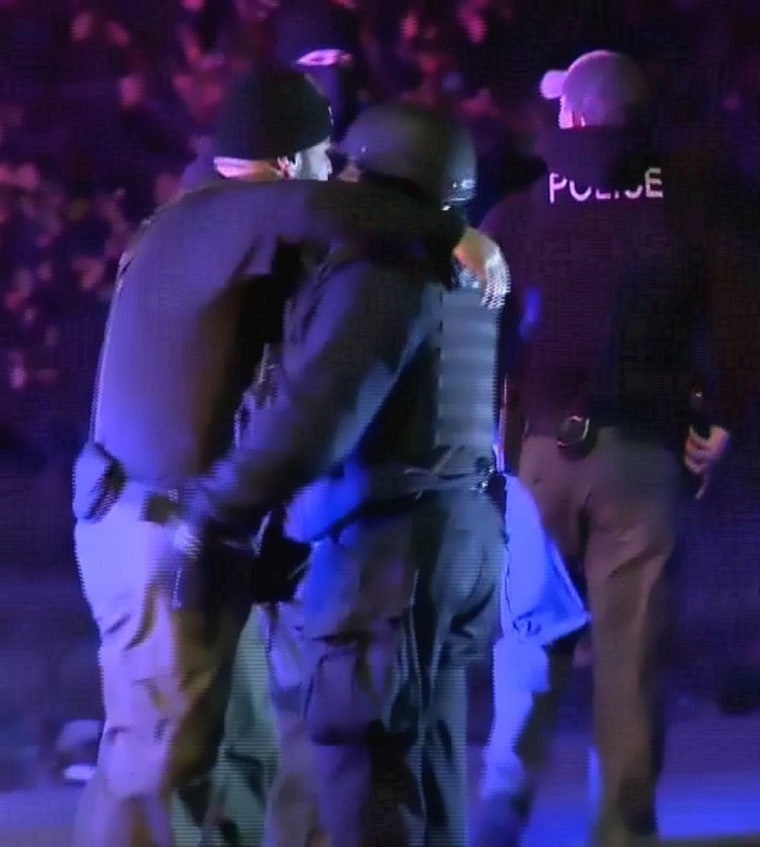 IMAGE: Police embrace after shooting