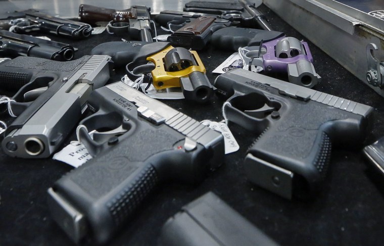 In this Saturday, Jan. 26, 2013 file photo, handguns are displayed on a vendor's table at an annual gun show in Albany, N.Y.