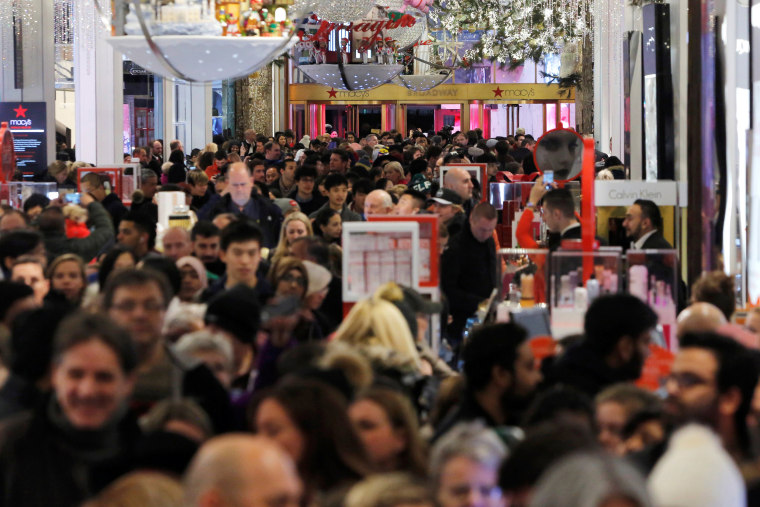 Image: People walk through Macy's Herald Square store during early opening for Black Friday sales in Manhattan, New York