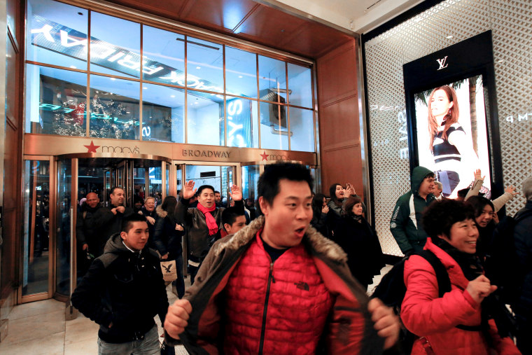 Image: People enter Macy's Herald Square for early opening of the Black Friday sales in Manhattan, New York