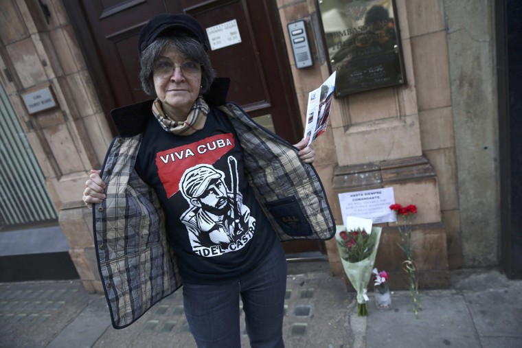 Image: A Cuban woman displays her tee shirt to the cameras after looking at tributes following the announcement of the death of Cuban revolutionary leader Fidel Castro, at the Cuban Embassy, in central London