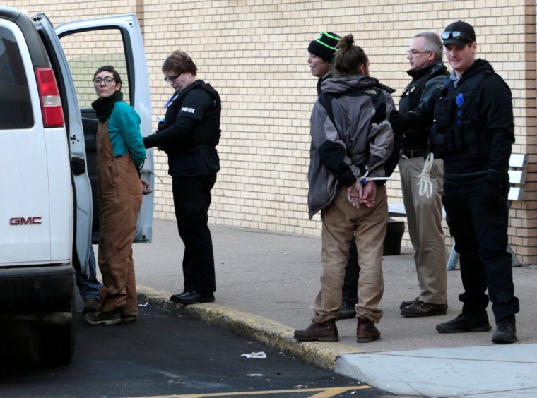 Image: A woman is taken into police custody outside an anti-Dakota Access Pipeline protest at Kirkwood Mall in Bismarck, North Dakota