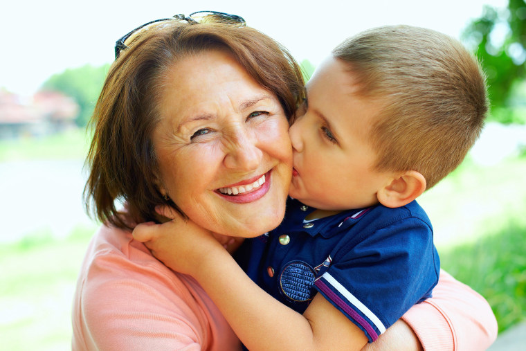 little boy hugging his grandmother