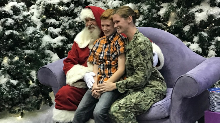 Military mom surprises son during visit to Santa.