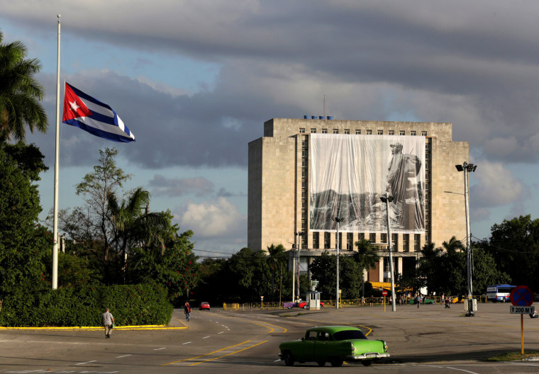 Image: A picture of Cuban former president Fidel Castro hangs in front of the Cuban National Library at Revolution Square in Havana