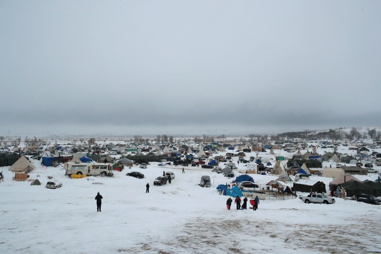 Image: Snow covers the ground at Oceti Sakowin Camp on Thursday
