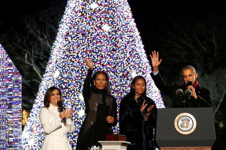 Image: Obama, joined by the first lady, their daughter Sasha and Longoria, reacts after pressing a button to light the National Christmas Tree in Washington