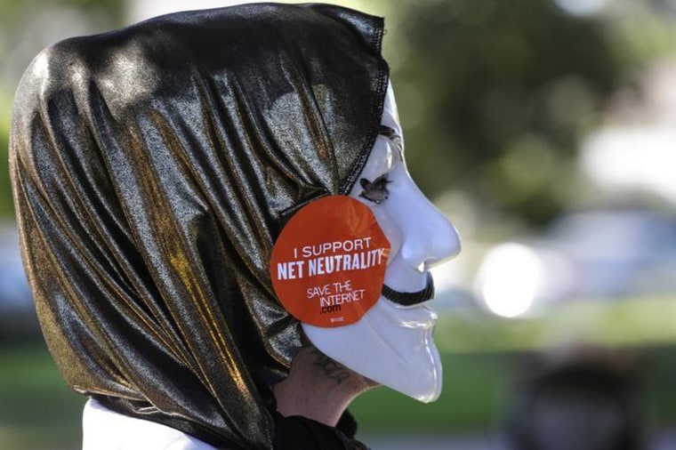 A pro-net neutrality Internet activist attends a rally in the neighborhood where U.S. Barack Obama attended a fundraiser in Los Angeles