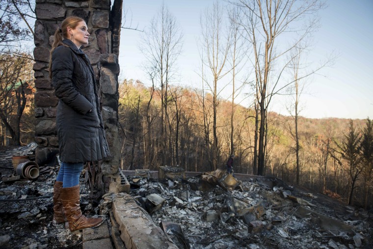 Veronica Carney looks at the skyline from the remains of the home she grew up in, Thursday, Dec. 1, 2016, in Gatlinburg, Tenn.