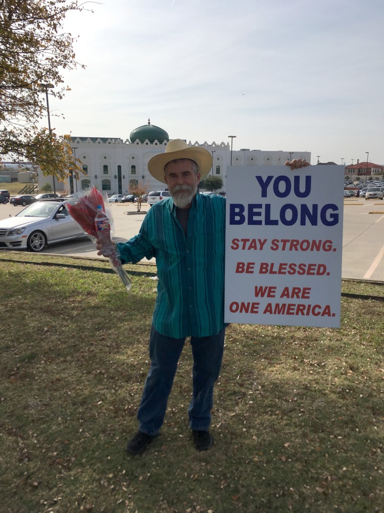 Justin Normand outside the Irving mosque holding the flowers was taken Saturday, Nov. 29.