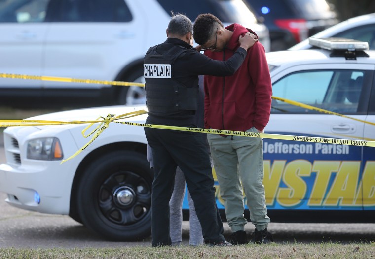 A young man is consoled by a chaplain as the Jefferson Parish Sheriff's Office investigates the homicide of former NFL player Joe McKnight at Behrman Highway and Holmes Blvd. in Terrytown on Thursday, Dec. 2, 2016.