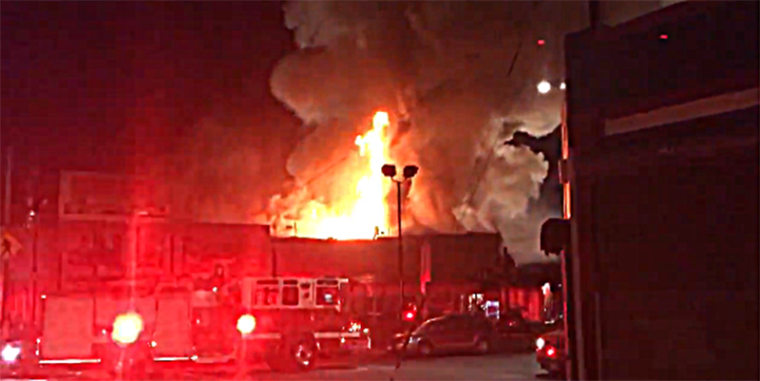 A warehouse fire burns late on Dec. 2 in Oakland, California.